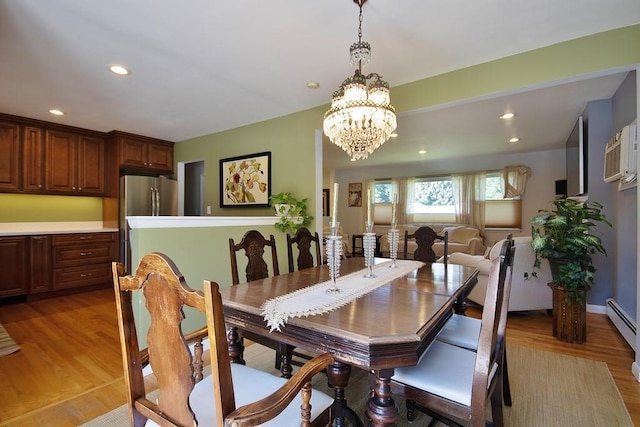 dining area featuring a notable chandelier, recessed lighting, and light wood-style floors