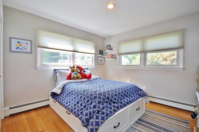 bedroom featuring a baseboard radiator and light wood-style floors