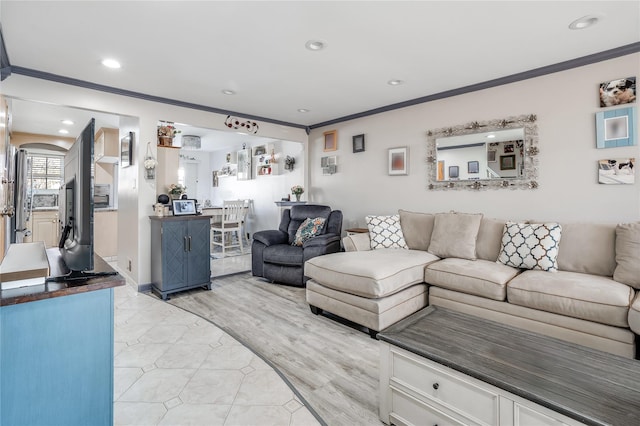 living room with ornamental molding, light wood-style floors, and recessed lighting