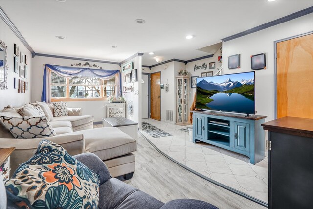 living room with ornamental molding, visible vents, recessed lighting, and light wood-type flooring
