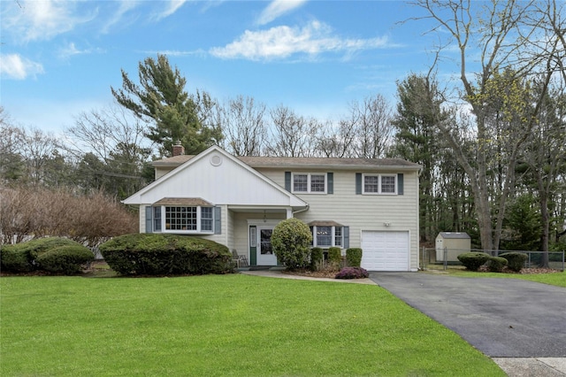 101 Grissom Way, Hauppauge, NY 11788 - tri-level home featuring a front yard, fence, an attached garage, a chimney, and driveway