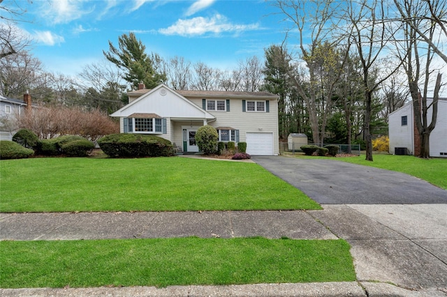 101 Grissom Way, Hauppauge, NY 11788 - view of front of property featuring an attached garage, a chimney, aphalt driveway, and a front yard