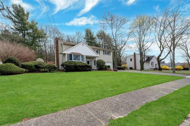 101 Grissom Way, Hauppauge, NY 11788 - split level home with a front lawn, a garage, driveway, and a chimney