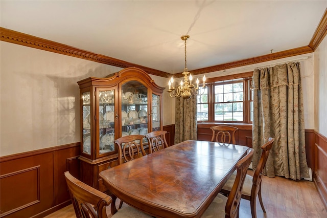 101 Grissom Way, Hauppauge, NY 11788 - dining space with a chandelier, light wood-style floors, crown molding, and a wainscoted wall