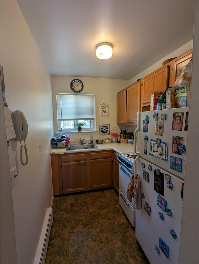 kitchen featuring light countertops, baseboard heating, brown cabinets, white appliances, and a sink