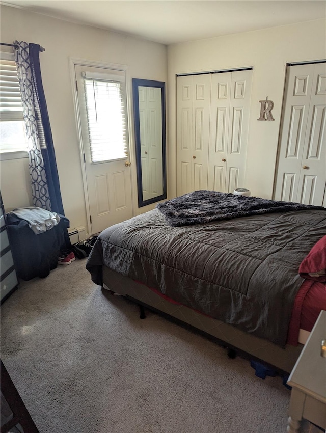 bedroom featuring carpet flooring and two closets