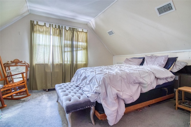 bedroom with visible vents, lofted ceiling, and carpet flooring