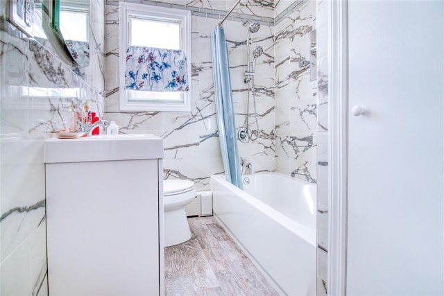 full bath featuring shower / bathtub combination with curtain, toilet, tile walls, and vanity