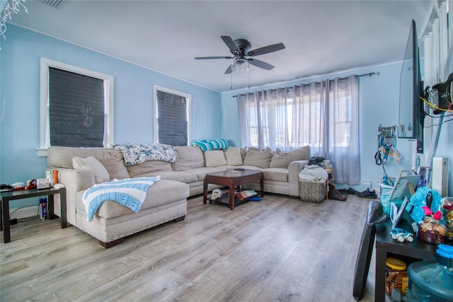 living room featuring ceiling fan and light wood finished floors