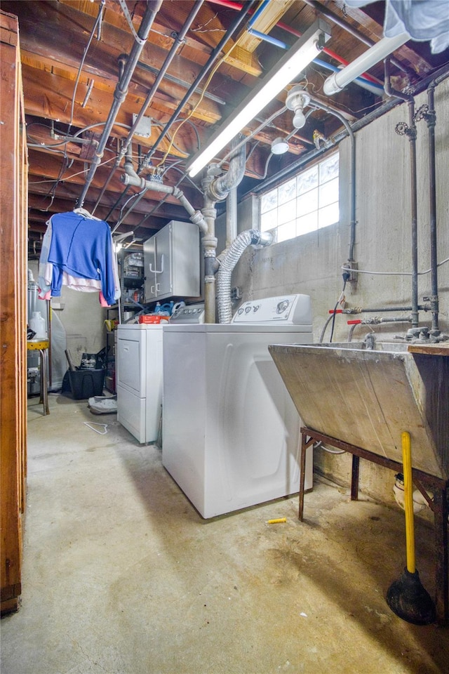 basement with a sink and washing machine and dryer