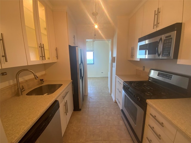 kitchen featuring a sink, appliances with stainless steel finishes, and white cabinets