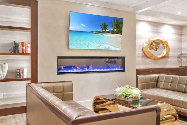 living area featuring a glass covered fireplace, wood finished floors, and recessed lighting