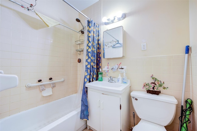 bathroom featuring vanity, tile walls, toilet, and shower / tub combo with curtain