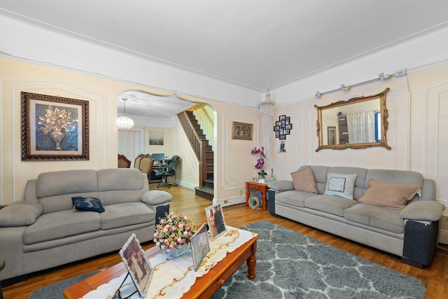 living area with wood finished floors and stairway