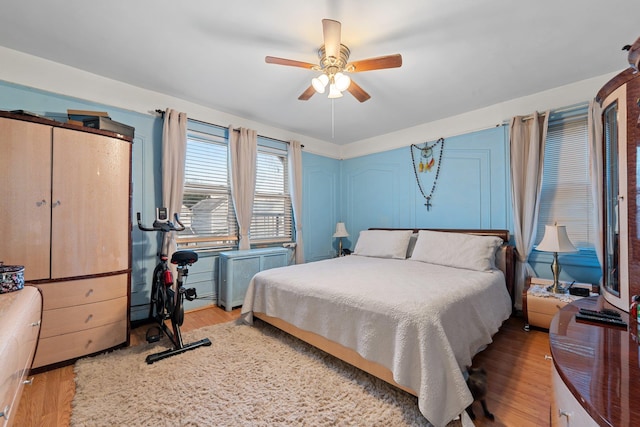 bedroom with a ceiling fan and wood finished floors