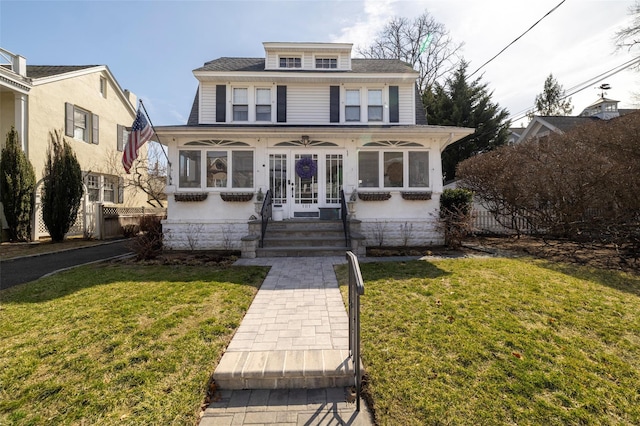 american foursquare style home featuring french doors, a front yard, and fence