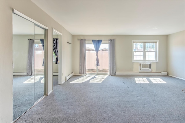 carpeted empty room with a wealth of natural light, a baseboard heating unit, and a baseboard radiator