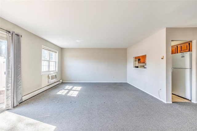 interior space with light carpet, a wall unit AC, baseboards, and a baseboard radiator