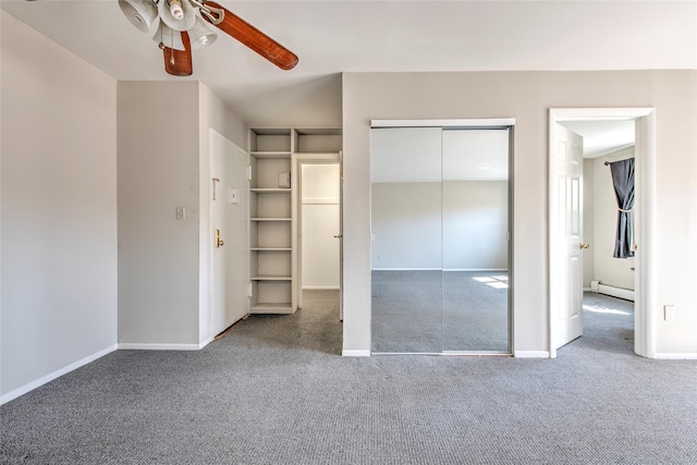 unfurnished bedroom with a ceiling fan, carpet, baseboards, and a baseboard radiator