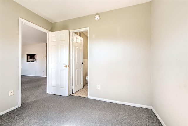 unfurnished bedroom featuring baseboards and carpet