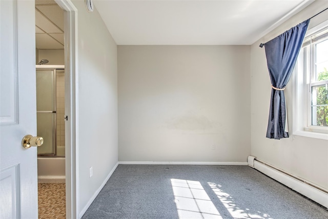 carpeted empty room featuring baseboards and baseboard heating