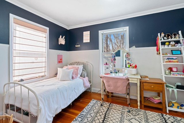 bedroom with multiple windows, crown molding, and wood finished floors