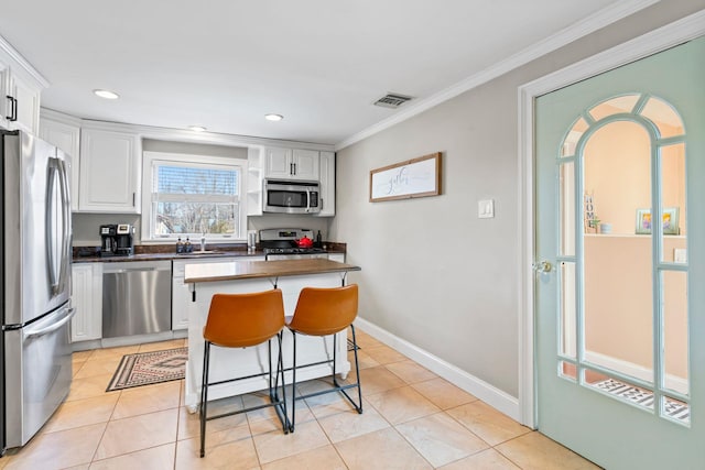 kitchen with dark countertops, visible vents, white cabinetry, and stainless steel appliances