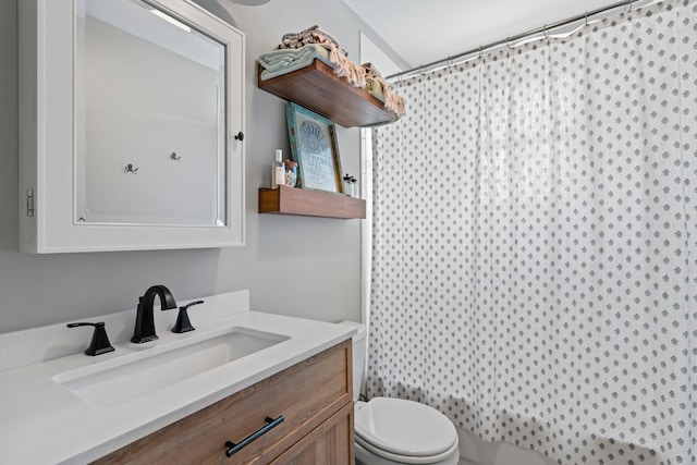 bathroom featuring vanity, toilet, and a shower with shower curtain