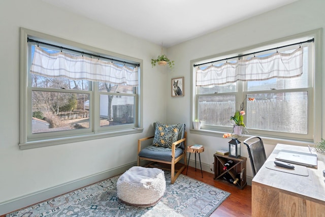 office area with baseboards, a healthy amount of sunlight, and wood finished floors