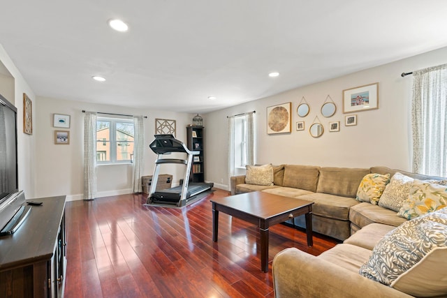 living room featuring recessed lighting, dark wood-style flooring, and baseboards