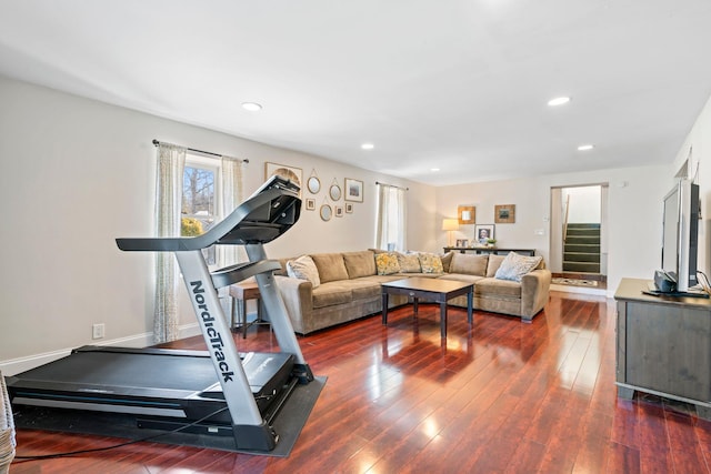 exercise area with dark wood finished floors and recessed lighting