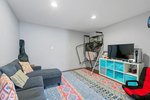 living area with recessed lighting, baseboards, and wood finished floors