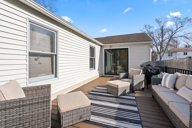 wooden terrace with a grill, outdoor lounge area, and fence