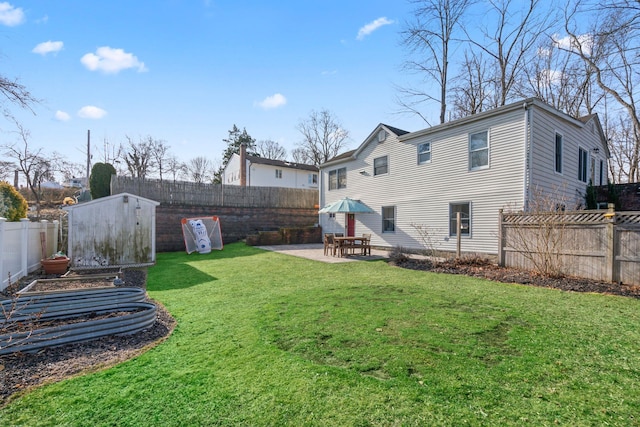 view of yard featuring a patio area, an outdoor structure, a storage shed, and a fenced backyard