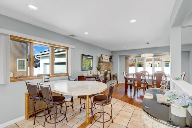 dining room with recessed lighting, visible vents, a fireplace, and light tile patterned floors