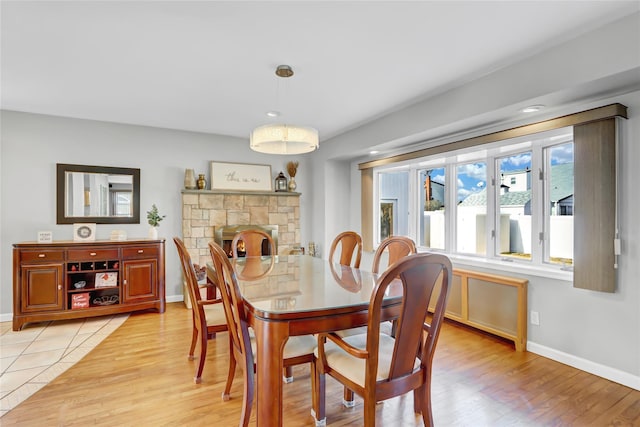 dining area featuring baseboards and light wood finished floors