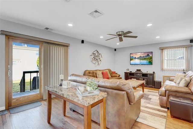 living area with recessed lighting, visible vents, and light wood finished floors