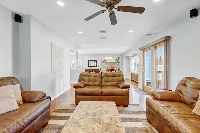 living area featuring visible vents, recessed lighting, light wood-type flooring, and a ceiling fan