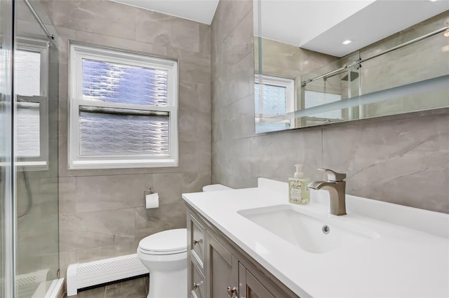 full bath featuring a wealth of natural light, baseboard heating, a stall shower, and tile walls