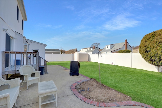 view of yard featuring a patio area, a residential view, and a fenced backyard