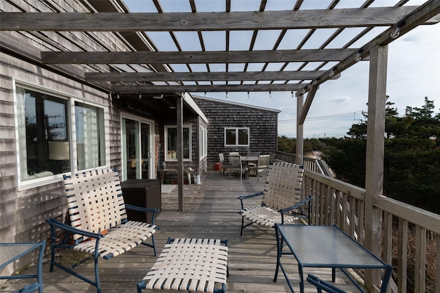 wooden terrace featuring outdoor dining space and a pergola