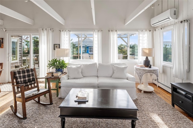 sunroom / solarium with vaulted ceiling, plenty of natural light, a baseboard radiator, and a wall mounted AC