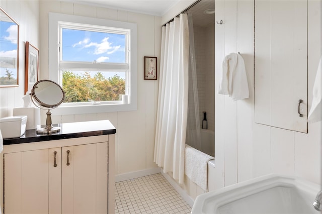 bathroom featuring tile patterned flooring, vanity, and shower / bathtub combination with curtain