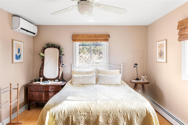 bedroom with baseboards, ceiling fan, an AC wall unit, light wood-type flooring, and baseboard heating