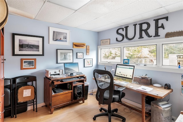 office featuring a drop ceiling and light wood-style flooring