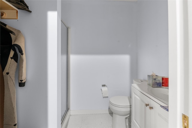 full bath with vanity, a shower stall, and toilet