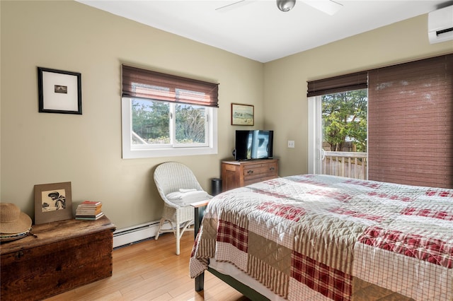 bedroom featuring a baseboard radiator, light wood-style flooring, ceiling fan, an AC wall unit, and access to outside