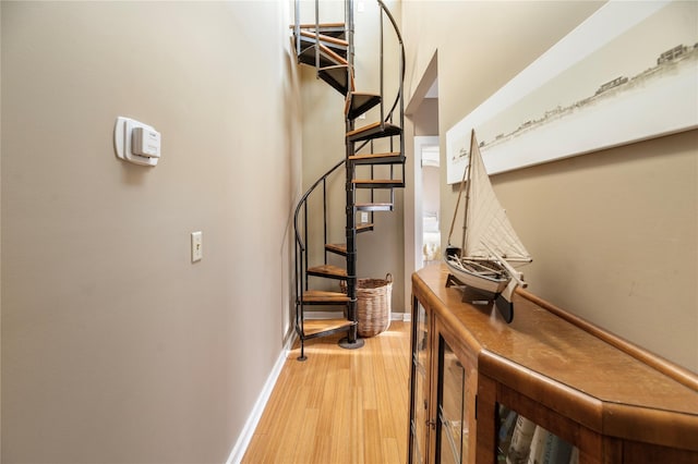 stairway featuring wood finished floors and baseboards