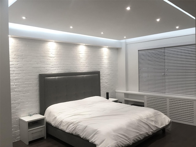 bedroom with wood finished floors and recessed lighting