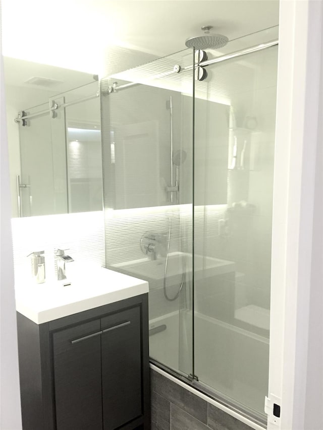 bathroom with a shower stall and vanity